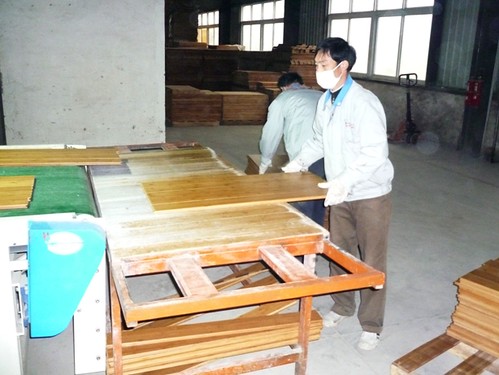 bamboo flooring quality control visual inspection as bamboo flooring flows off the line prior to packing.